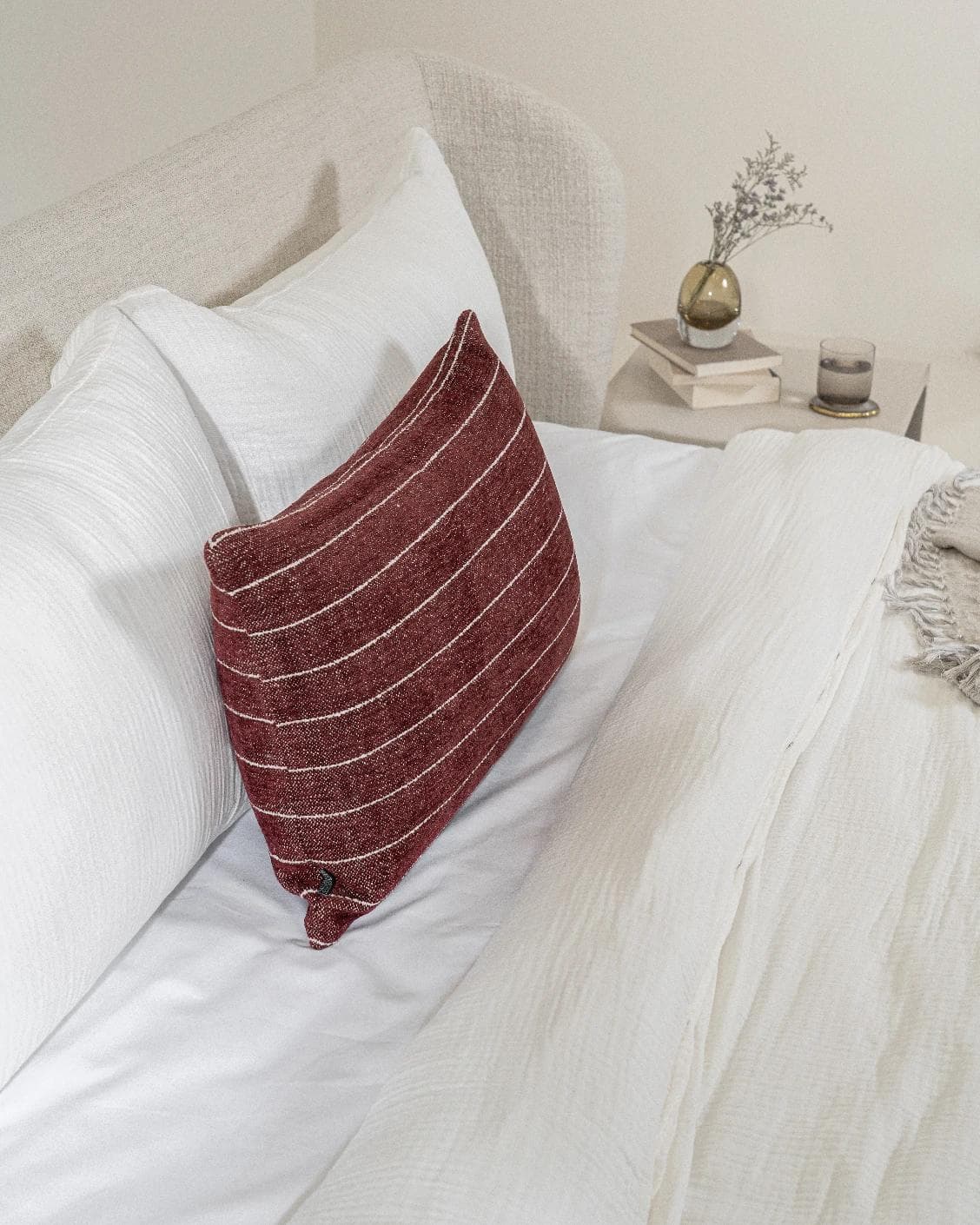 Noa Scarlet III cushion in burgundy, shown in a lifestyle left view as image 5