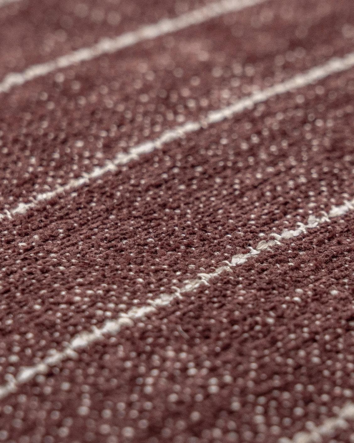 Noa Scarlet III cushion in burgundy, shown in a product close-up top view as image 7