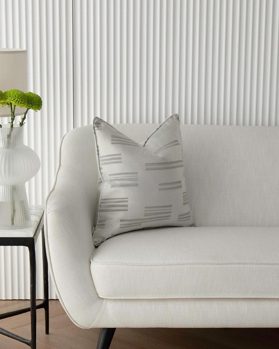 Nolan Laurent cushion in silver and grey, shown in a lifestyle front view as image 4