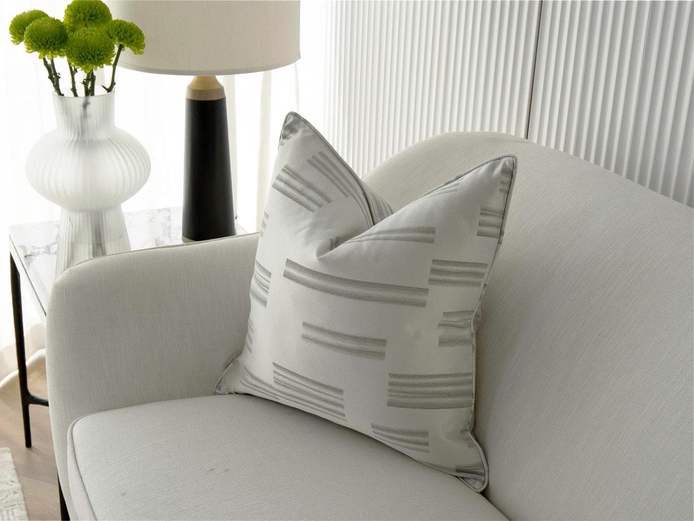 Nolan Laurent cushion in silver and grey, shown in a lifestyle right view as image 2