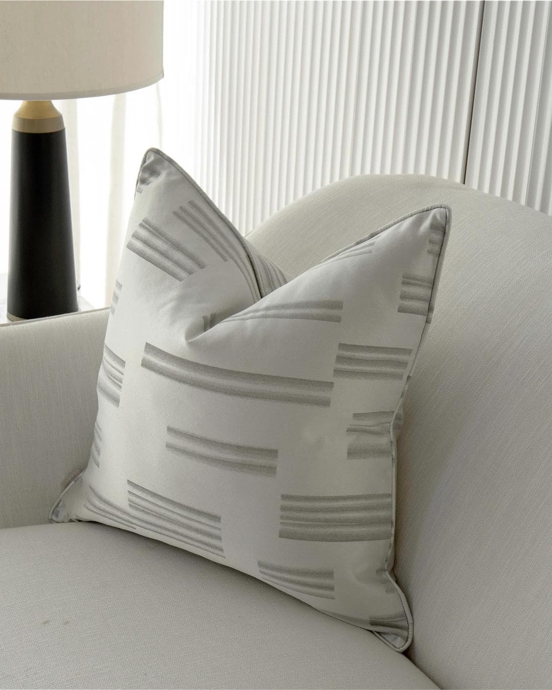 Nolan Laurent cushion in silver and grey, shown in a lifestyle right view as image 2
