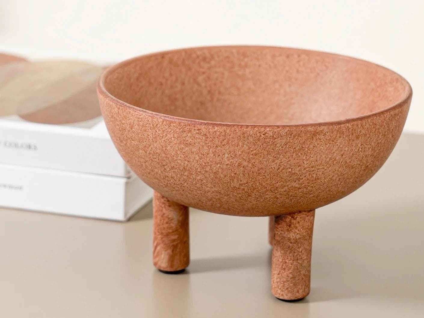 Nuva Terra bowls in orange, shown in a lifestyle front view as image 2