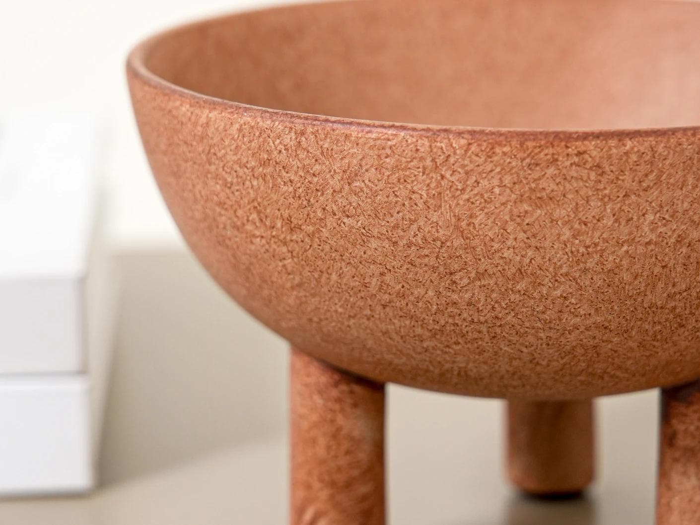 Nuva Terra bowls in orange, shown in a lifestyle left view as image 5