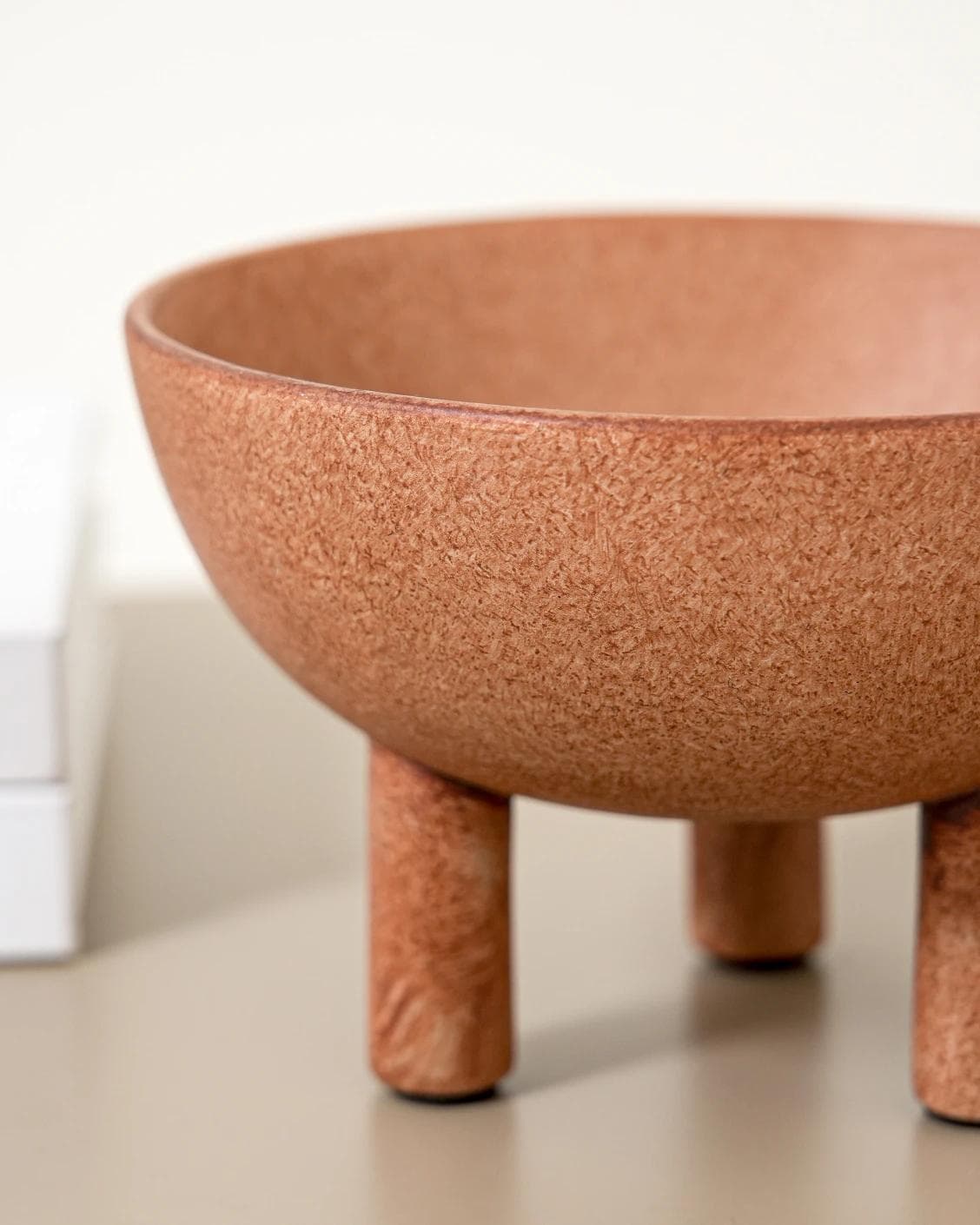 Nuva Terra bowls in orange, shown in a lifestyle left view as image 5