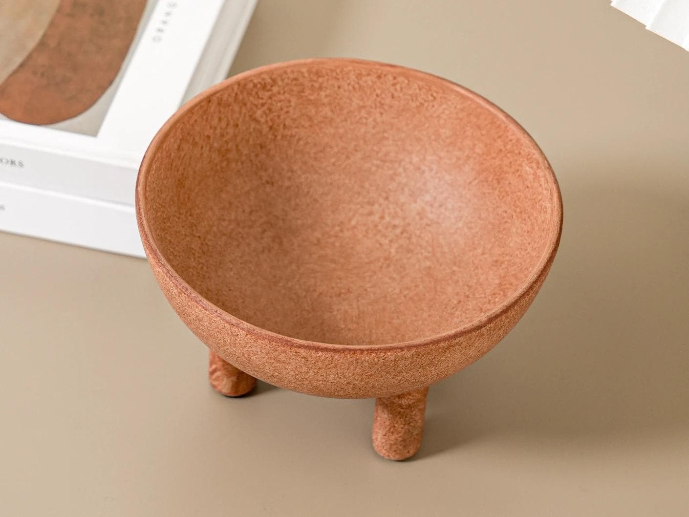 Nuva Terra bowls in orange, shown in a lifestyle top view as image 6