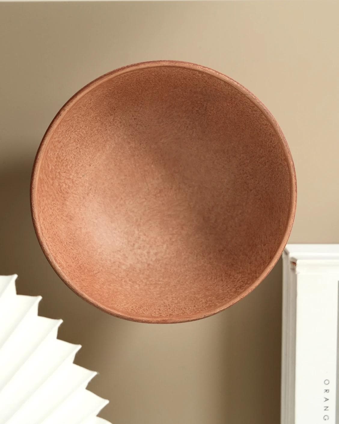 Nuva Terra bowls in orange, shown in a lifestyle top view as image 7