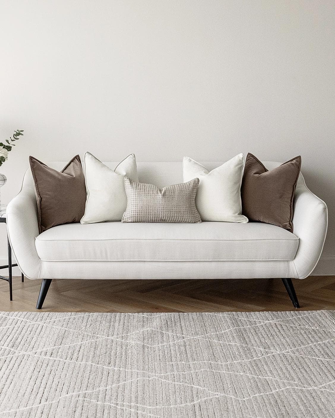 Oliver Bundle cushion in brown, white and silver, shown in a lifestyle front view as image 4