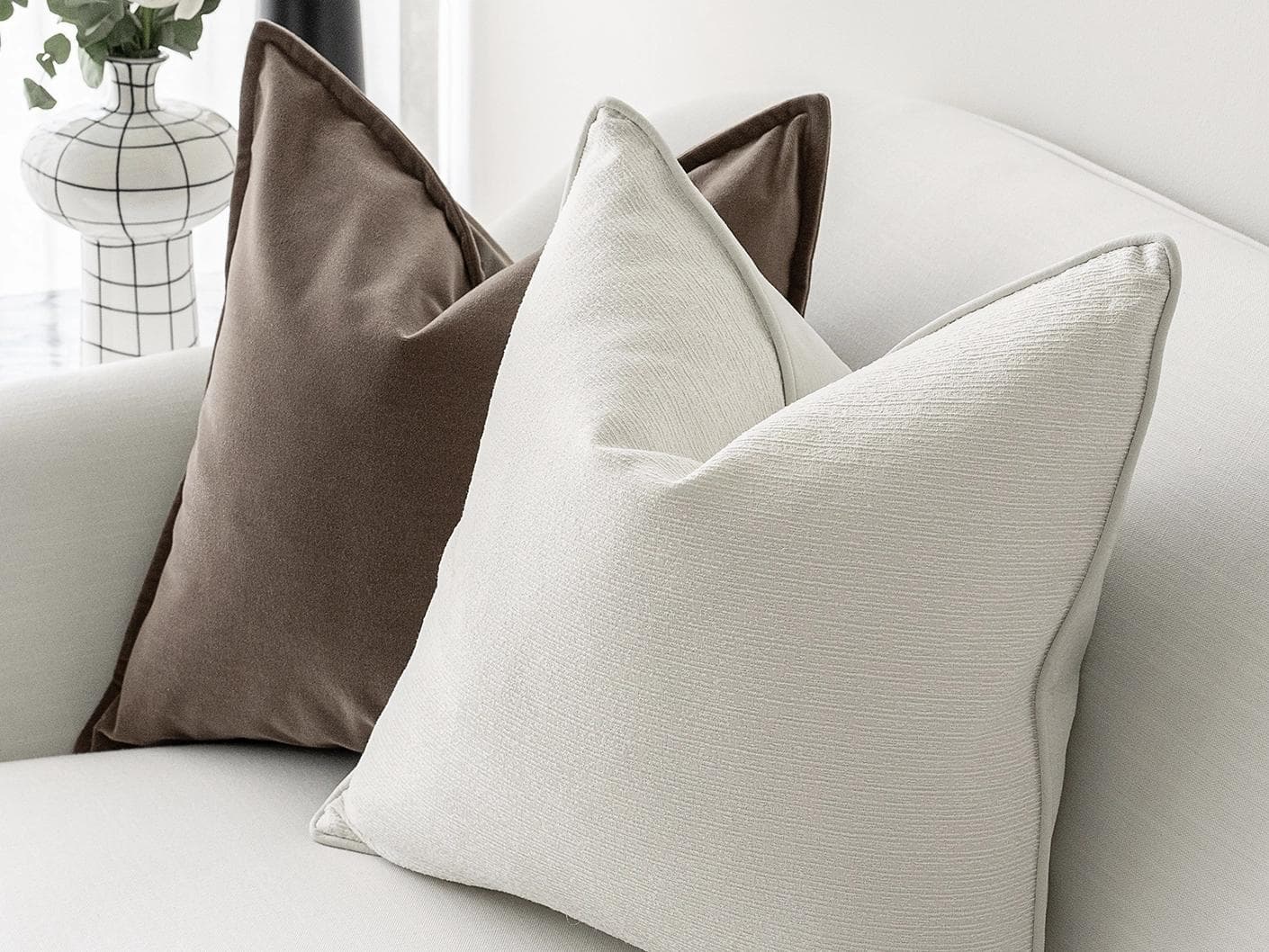 Oliver Bundle cushion in brown, white and silver, shown in a lifestyle right view as image 5