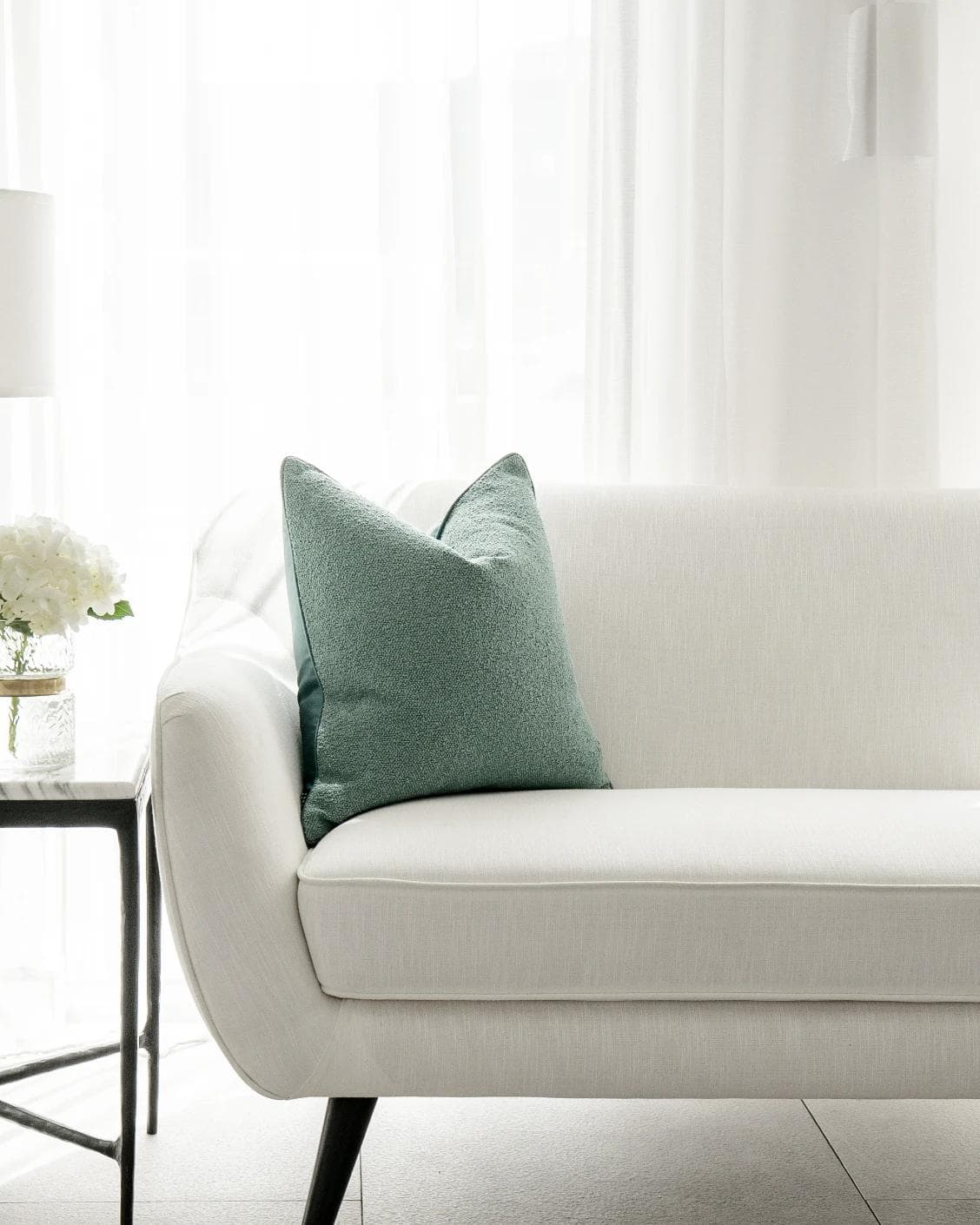 Oliver Sage cushion in green, shown in a lifestyle front view as image 4