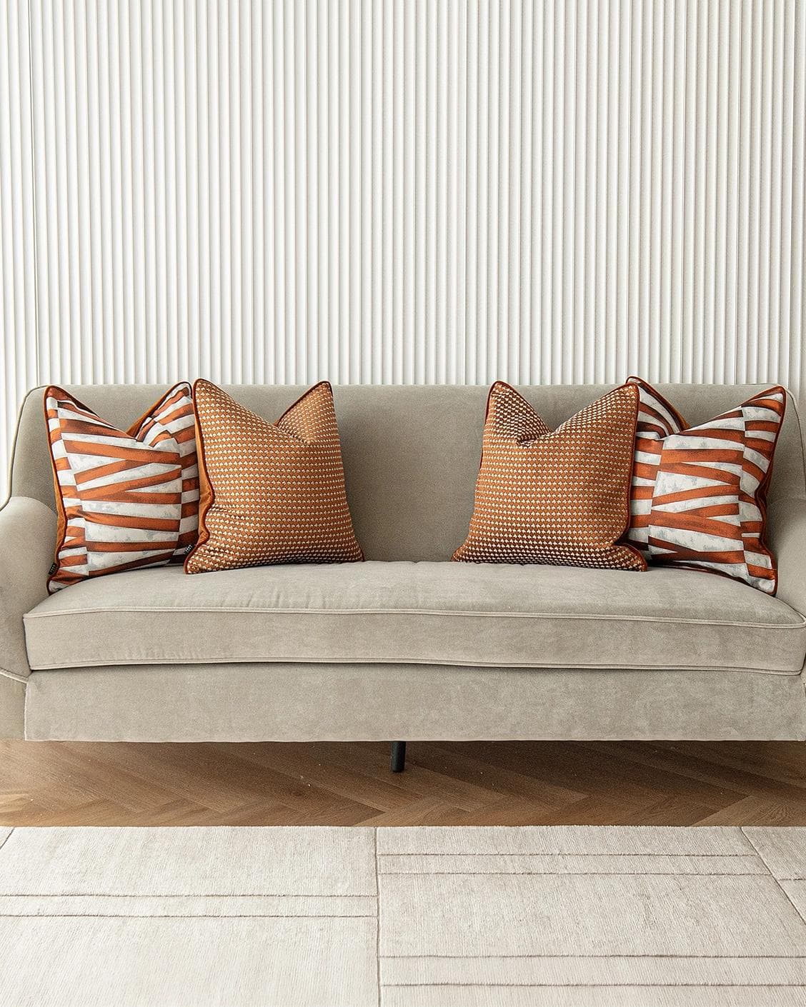 Alfred Bundle cushion in orange and white, shown in a lifestyle front view as image 4