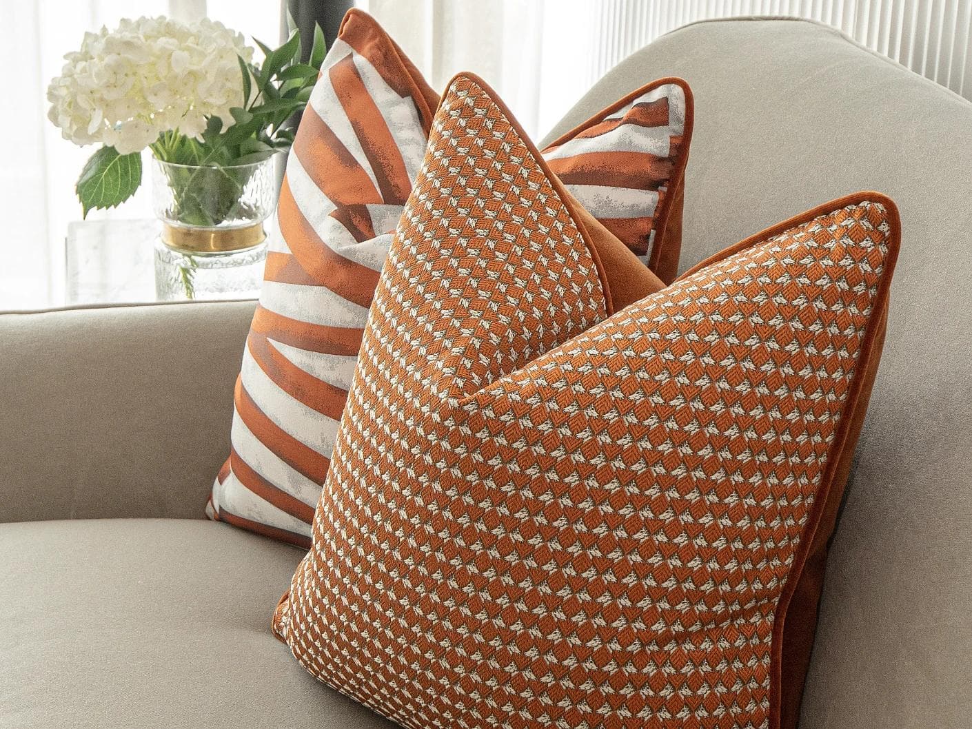 Alfred Bundle cushion in orange and white, shown in a lifestyle right view as image 6