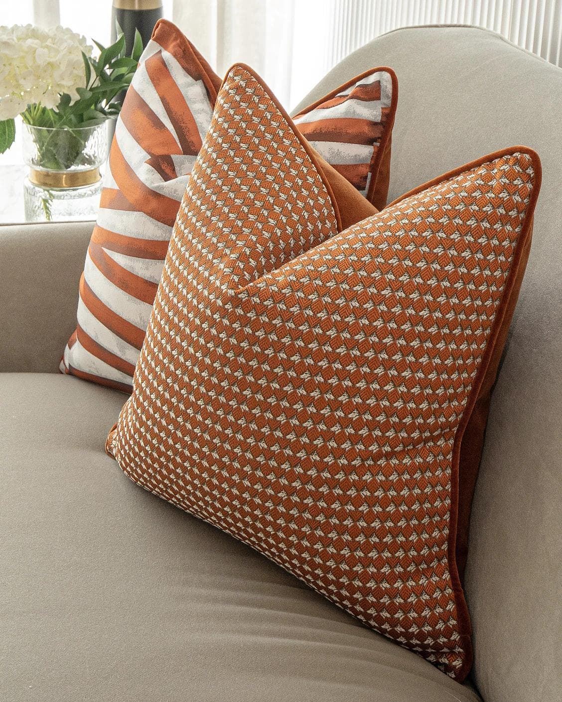 Alfred Bundle cushion in orange and white, shown in a lifestyle right view as image 6