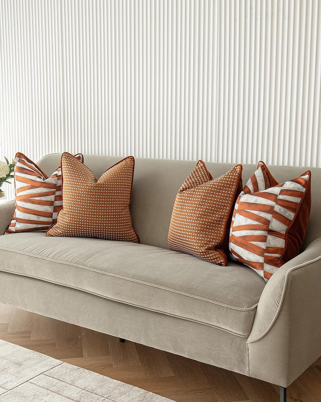 Alfred Bundle cushion in orange and white, shown in a lifestyle right view as image 2