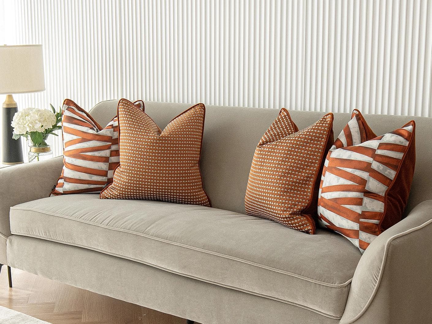 Alfred Bundle cushion in orange and white, shown in a lifestyle right view as image 2