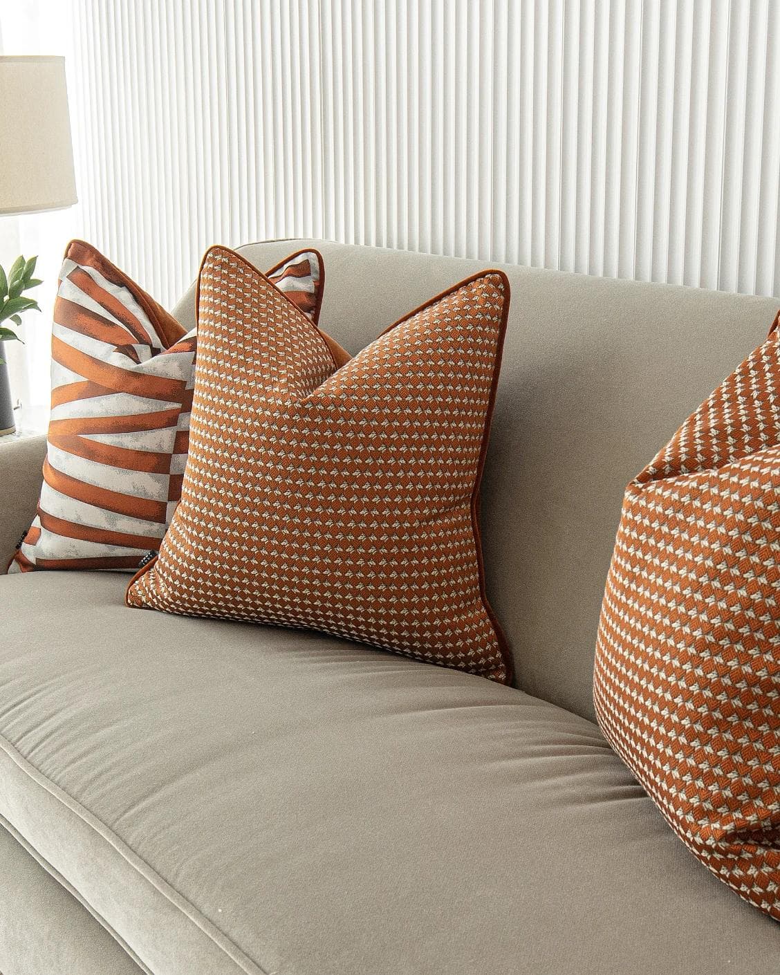 Alfred Bundle cushion in orange and white, shown in a lifestyle right view as image 7