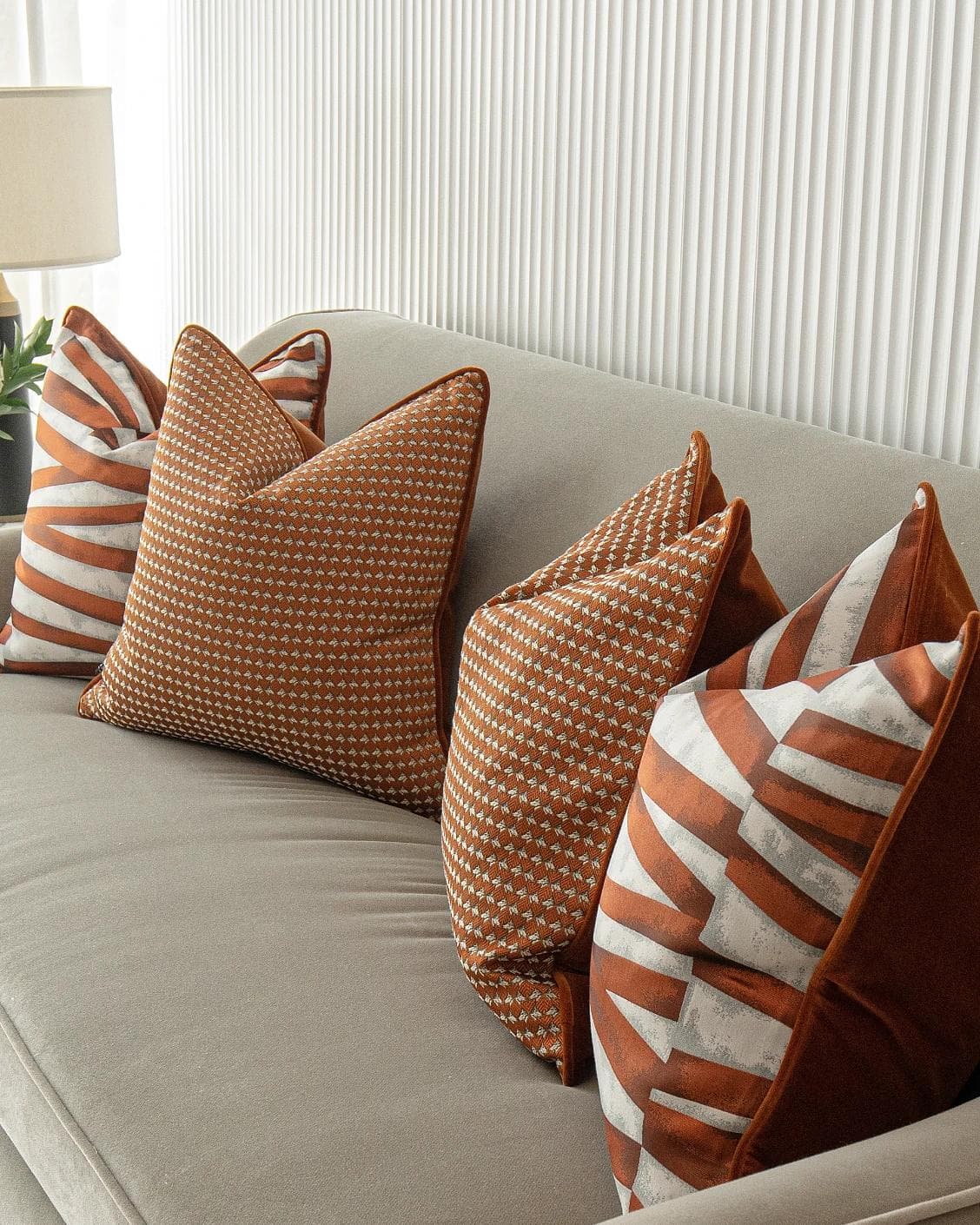 Alfred Bundle cushion in orange and white, shown in a lifestyle right view as image 8