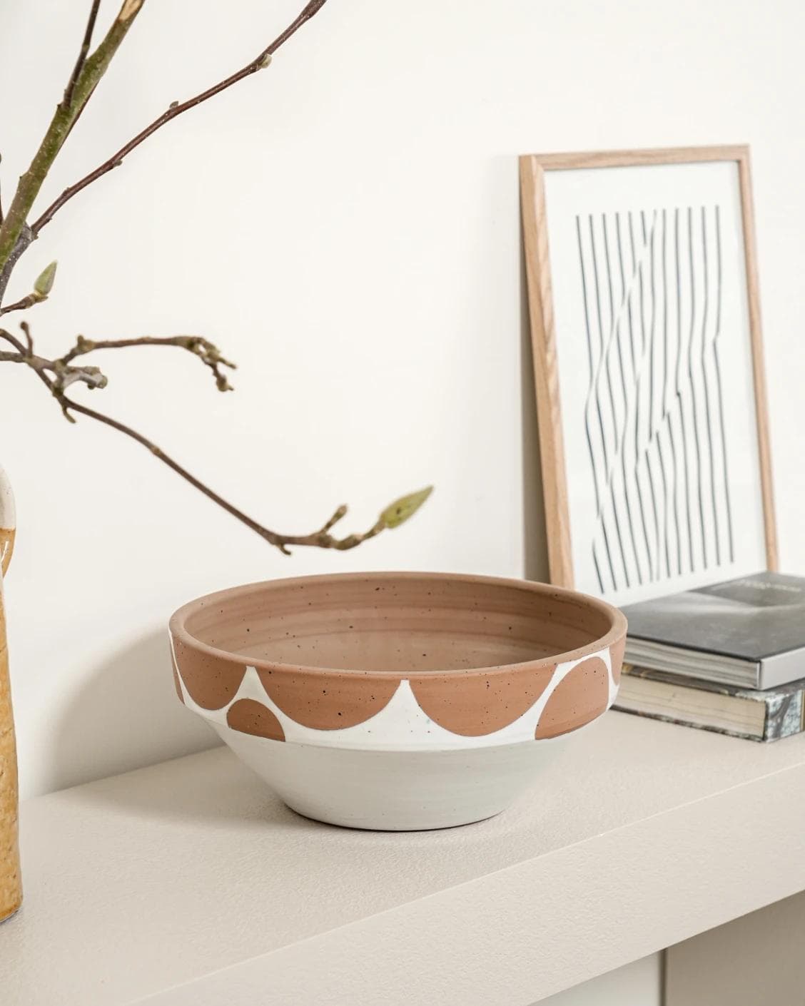 Oris Terra bowls in soft ivory, beige and white, shown in a lifestyle left view as image 2