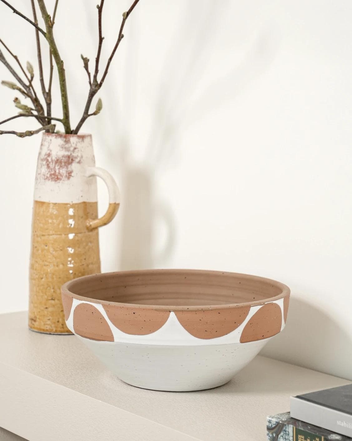 Oris Terra bowls in soft ivory, beige and white, shown in a lifestyle right view as image 6