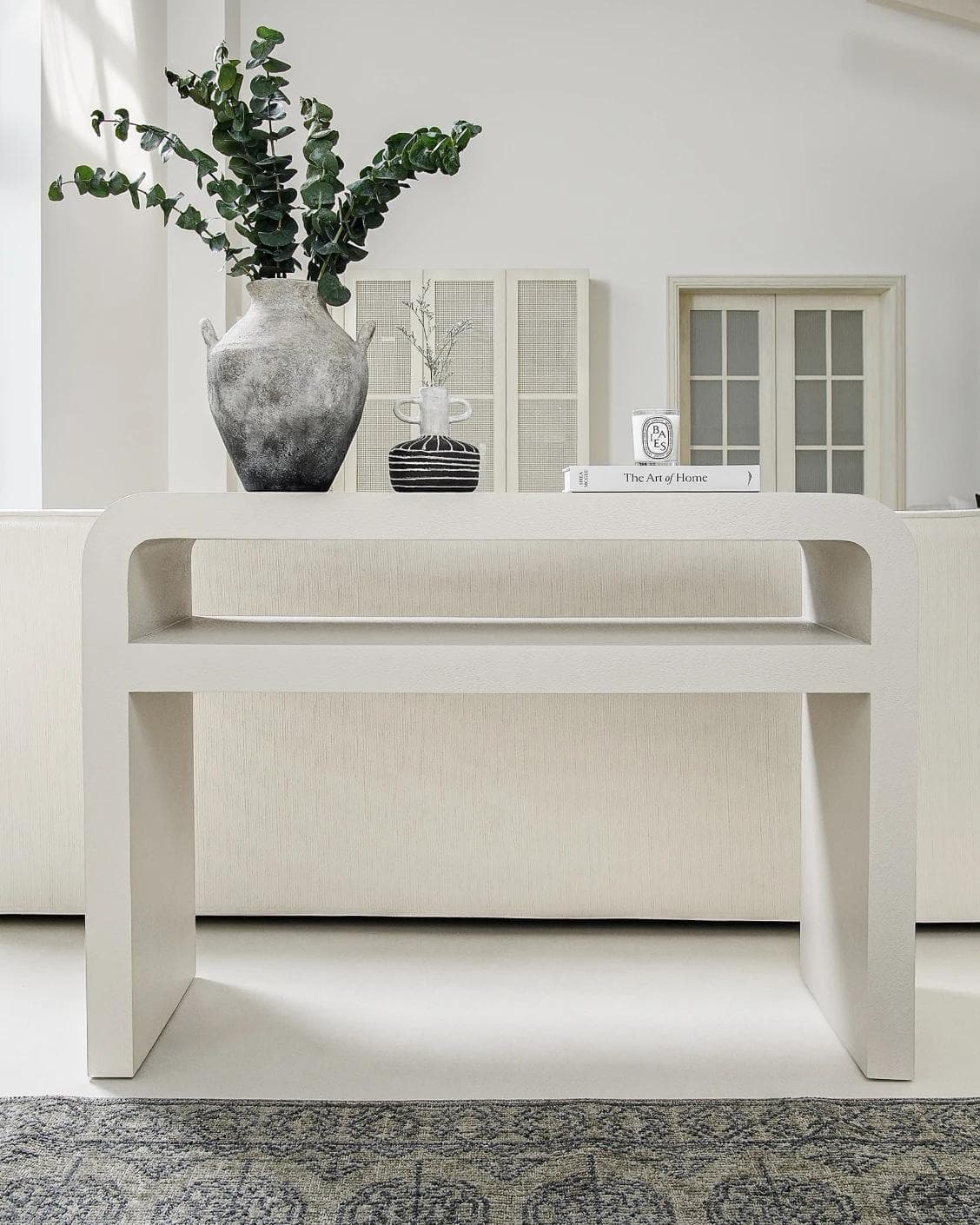Orta console table in soft ivory and stone, shown in a lifestyle front view as image 2