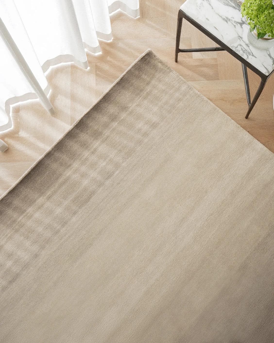 Oscar Ashton carpet in beige, shown in a lifestyle top view as image 2