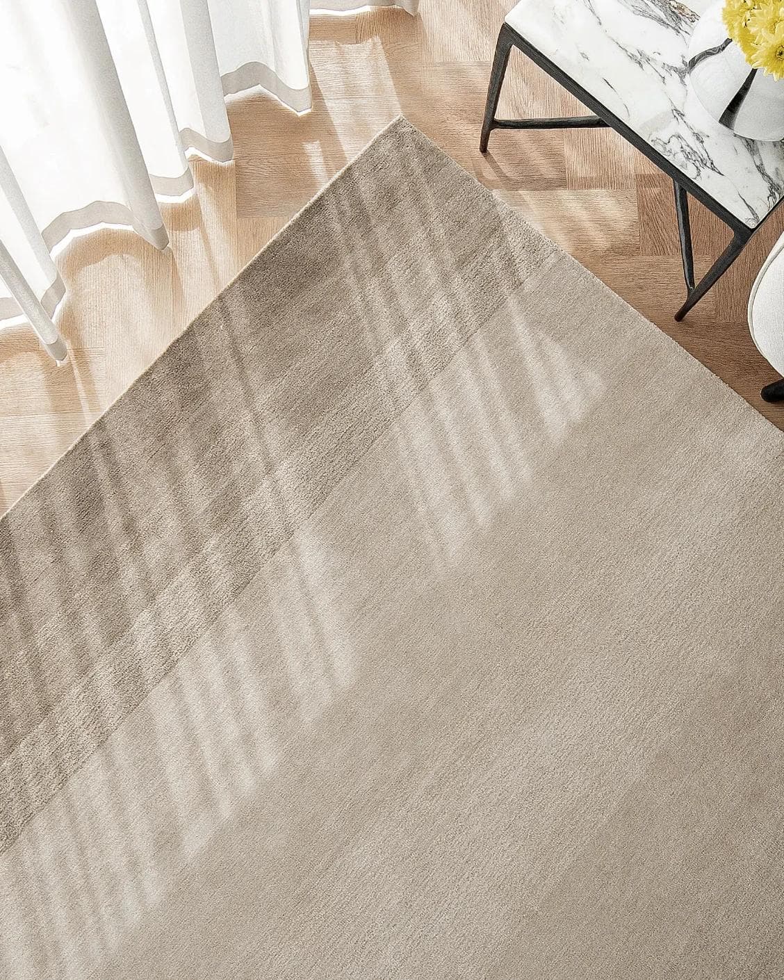 Oscar Dune carpet in beige, shown in a lifestyle top view as image 2