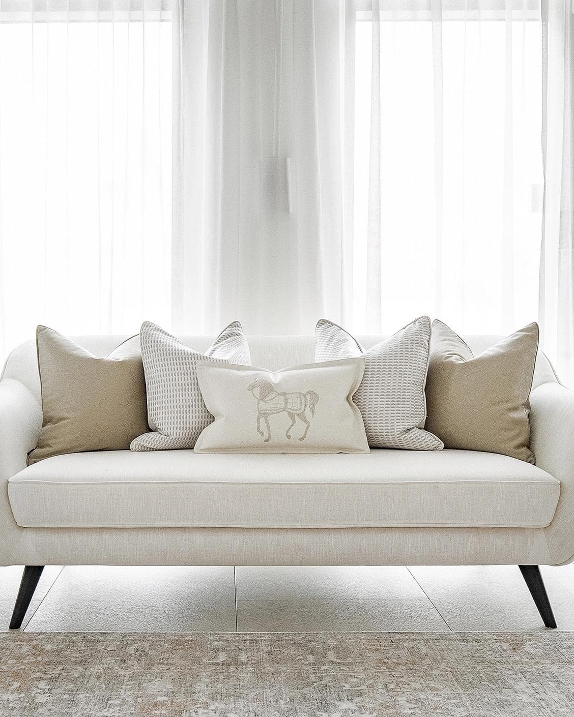 Elgine Bundle cushion in gold, beige and white, shown in a lifestyle front view as image 4
