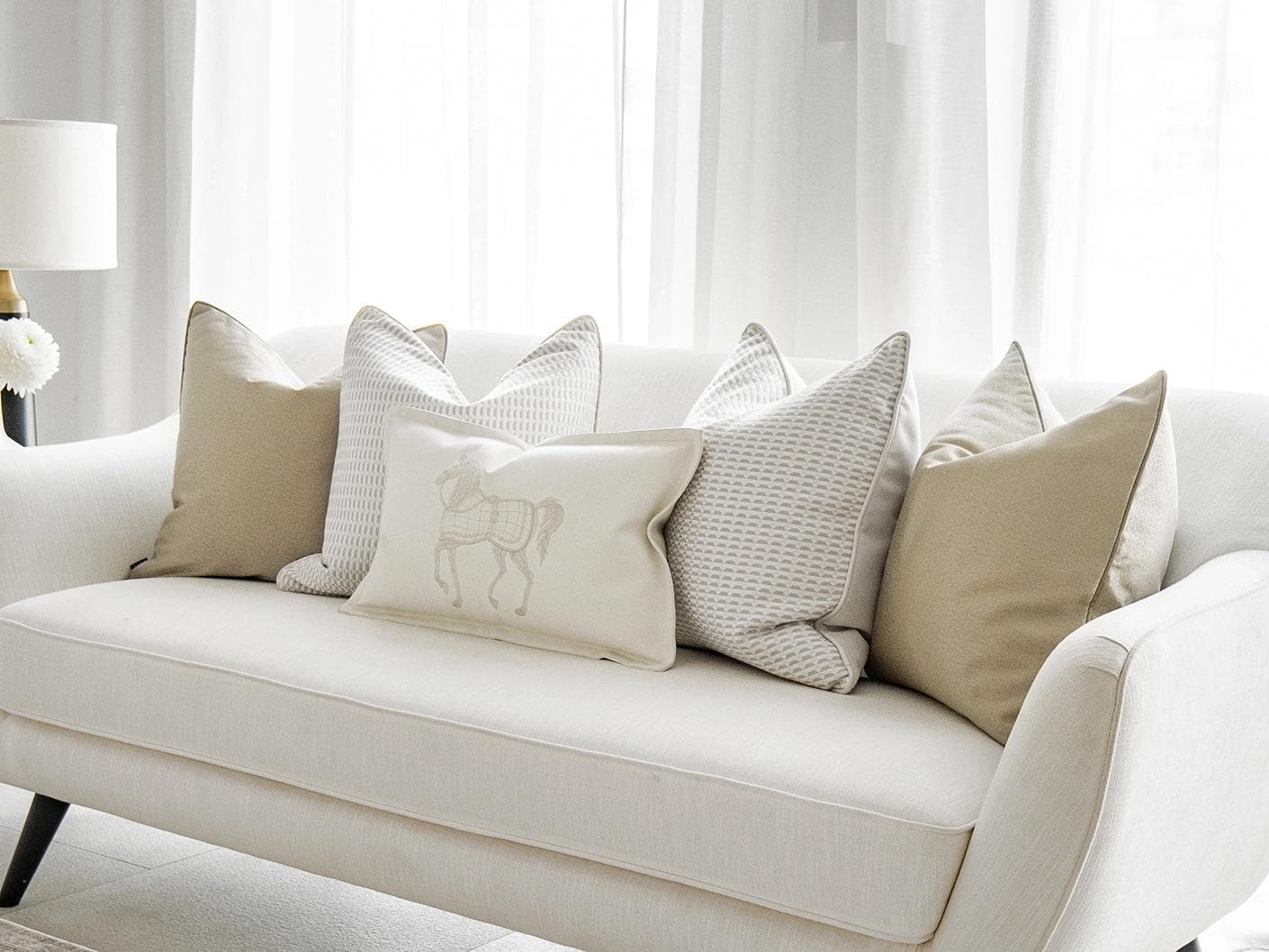 Elgine Bundle cushion in gold, beige and white, shown in a lifestyle right view as image 2