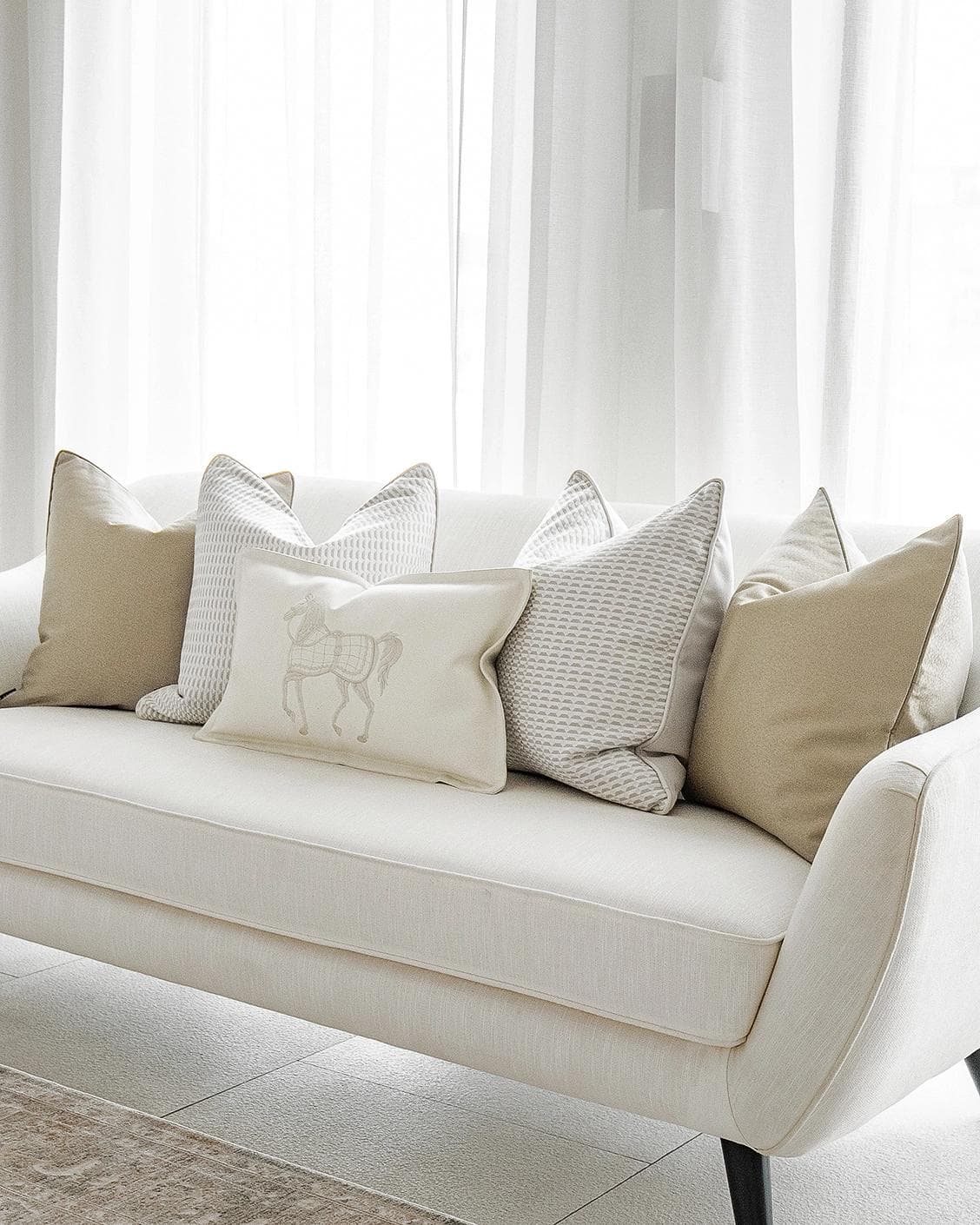 Elgine Bundle cushion in gold, beige and white, shown in a lifestyle right view as image 2