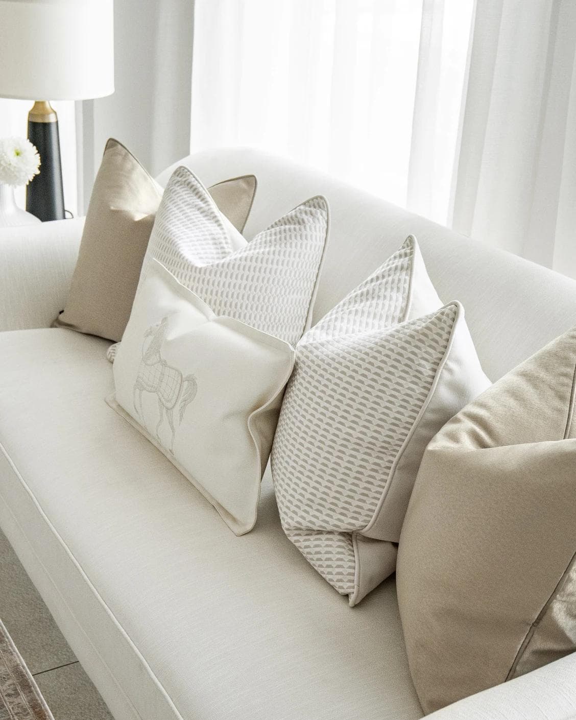 Elgine Bundle cushion in gold, beige and white, shown in a lifestyle top view as image 5