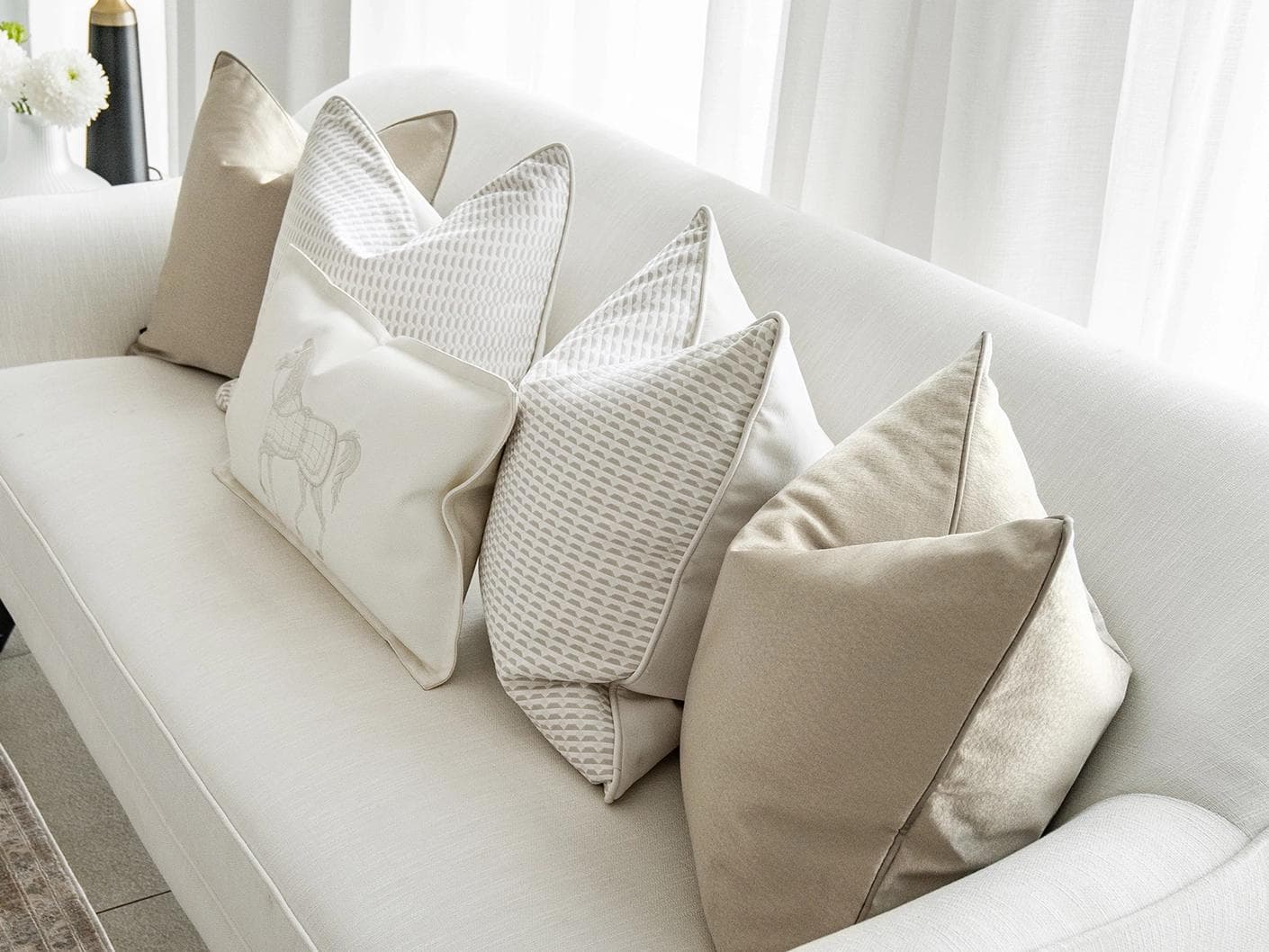 Elgine Bundle cushion in gold, beige and white, shown in a lifestyle top view as image 5