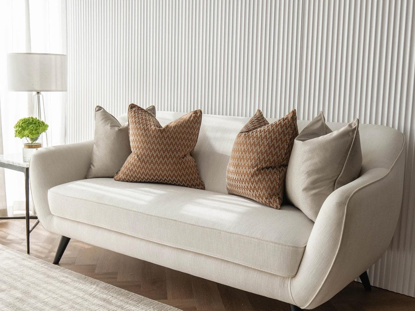 Amalia Bundle cushion in gold, orange and beige, shown in a lifestyle right view as image 2