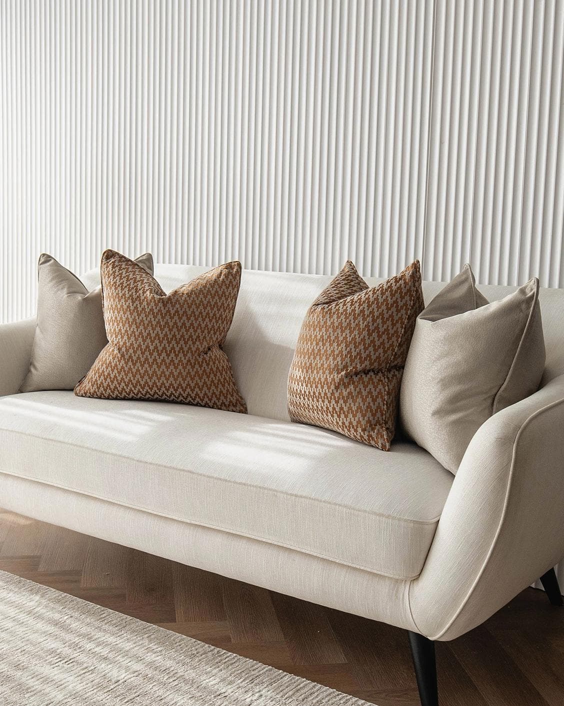 Amalia Bundle cushion in gold, orange and beige, shown in a lifestyle right view as image 2