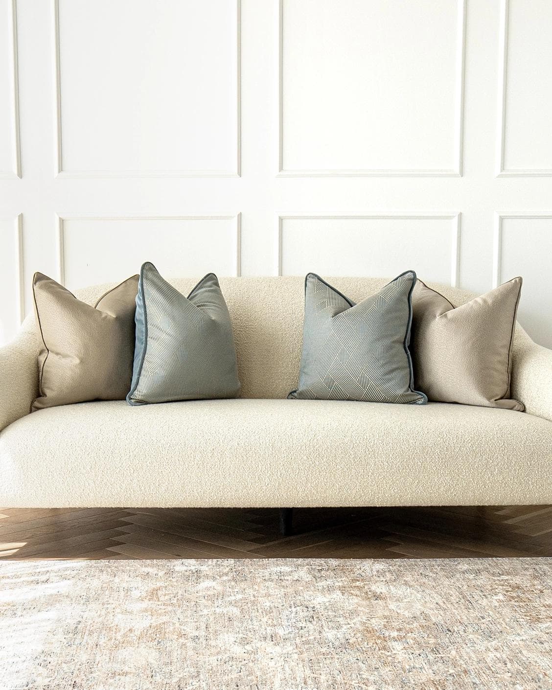 Juno Bundle cushion in gold, beige and blue, shown in a lifestyle front view as image 4