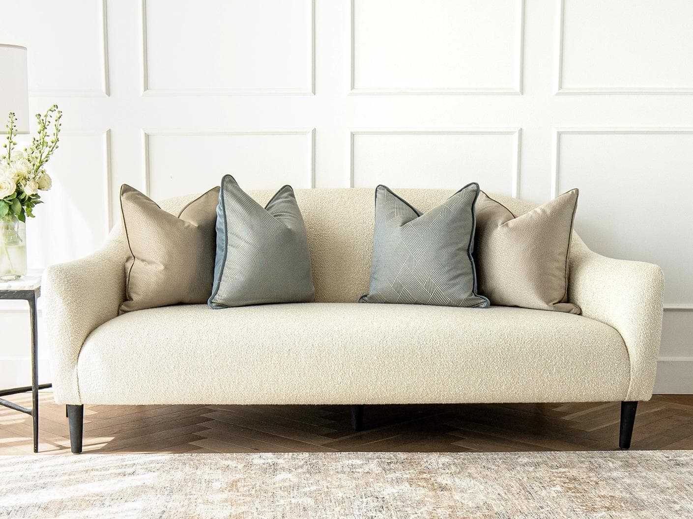 Juno Bundle cushion in gold, beige and blue, shown in a lifestyle front view as image 4