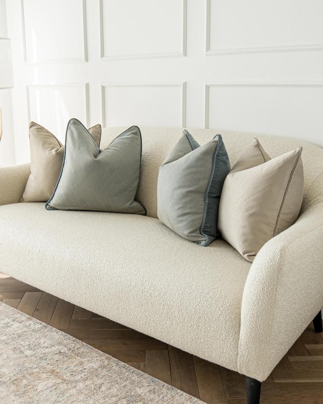 Juno Bundle cushion in gold, beige and blue, shown in a lifestyle right view as image 2