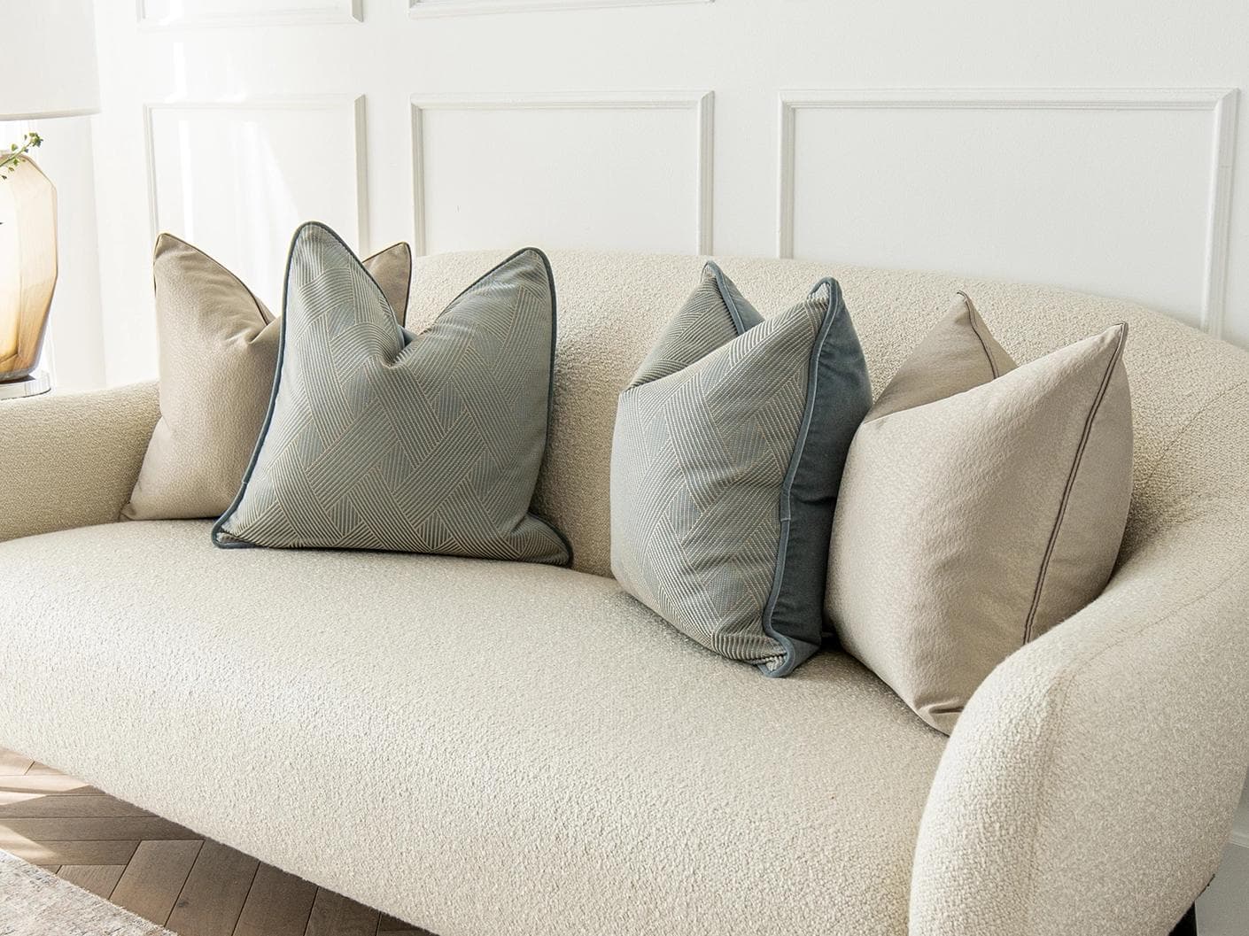 Juno Bundle cushion in gold, beige and blue, shown in a lifestyle right view as image 2