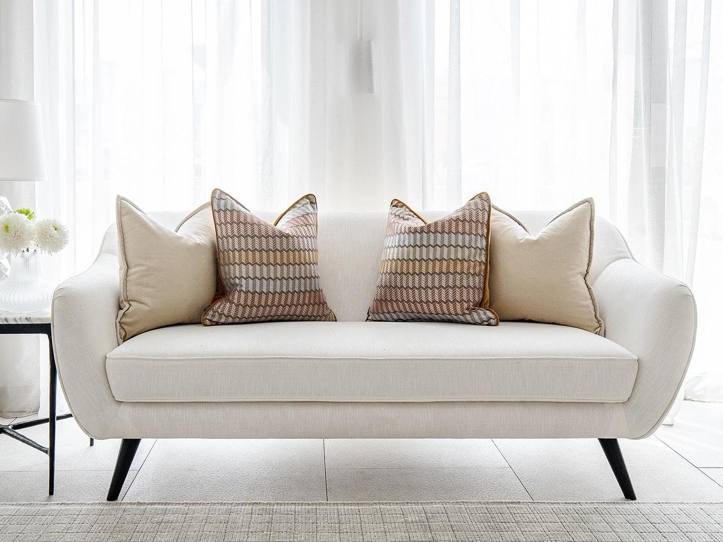 Elanor Bundle cushion in orange, yellow, beige and silver, shown in a lifestyle front view as image 4