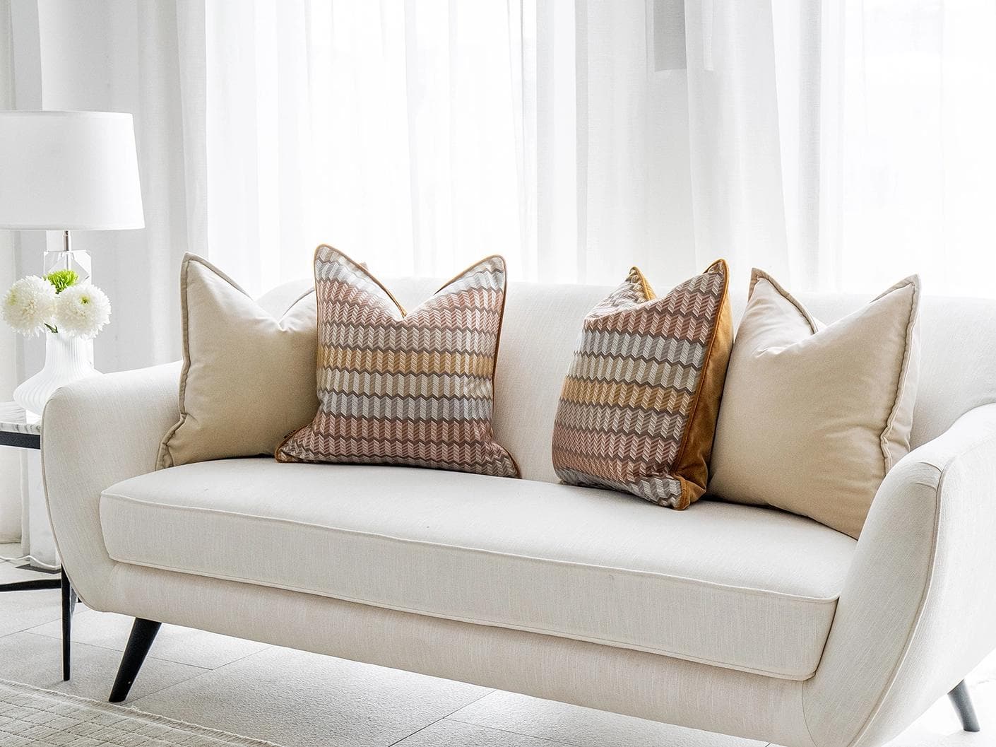 Elanor Bundle cushion in orange, yellow, beige and silver, shown in a lifestyle right view as image 2