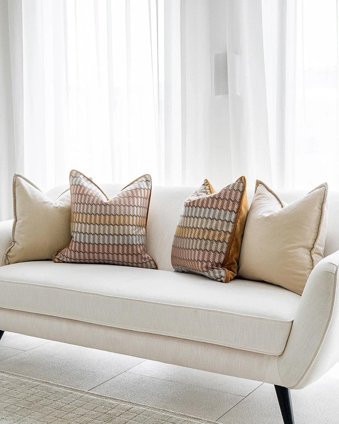 Elanor Bundle cushion in orange, yellow, beige and silver, shown in a lifestyle right view as image 2