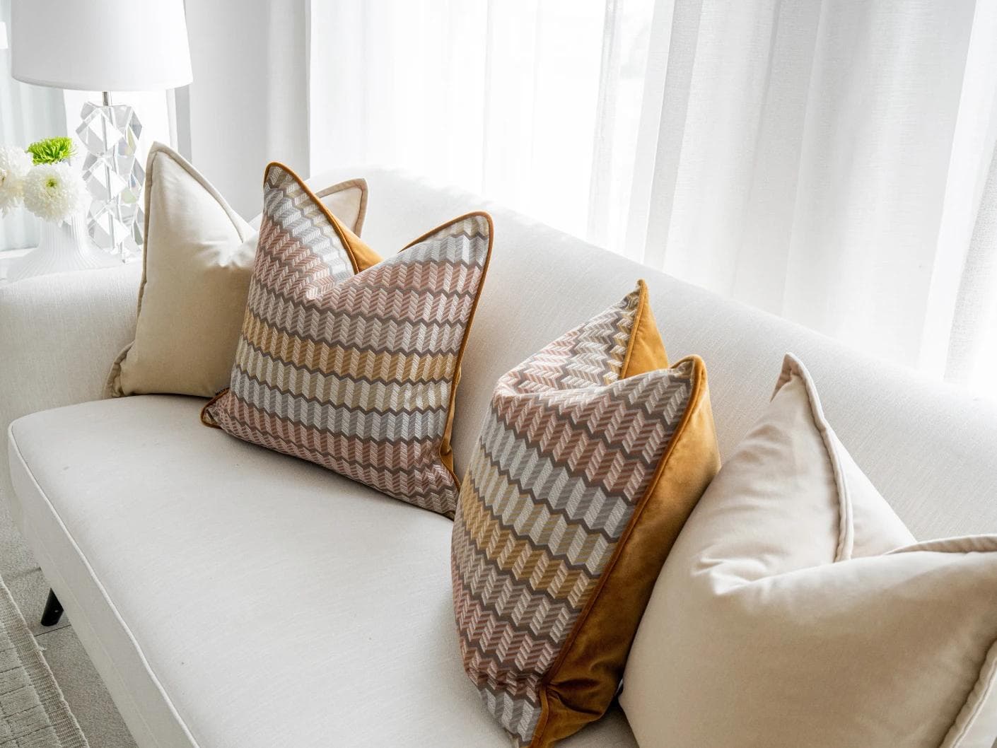 Elanor Bundle cushion in orange, yellow, beige and silver, shown in a lifestyle right view as image 5
