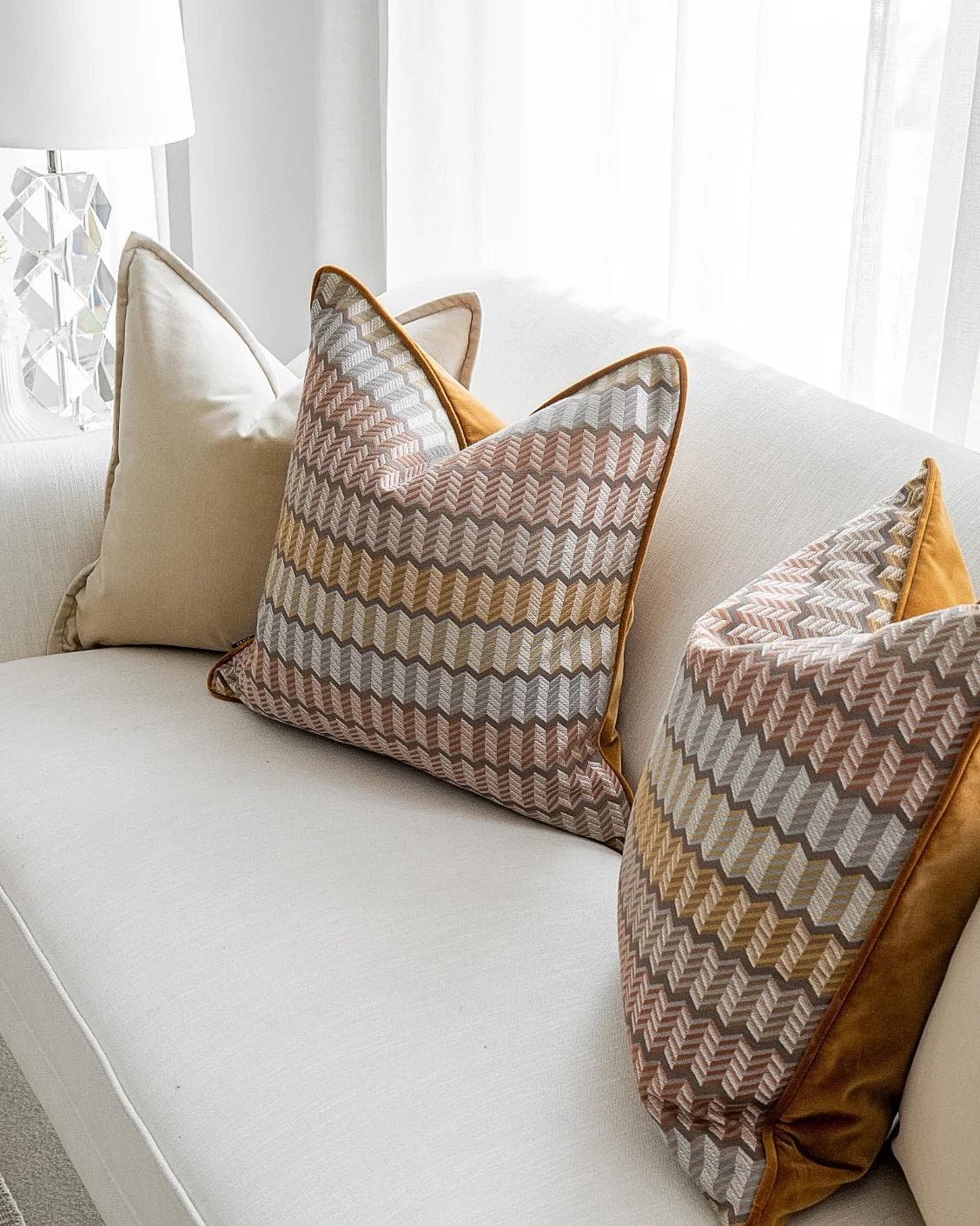 Elanor Bundle cushion in orange, yellow, beige and silver, shown in a lifestyle right view as image 5