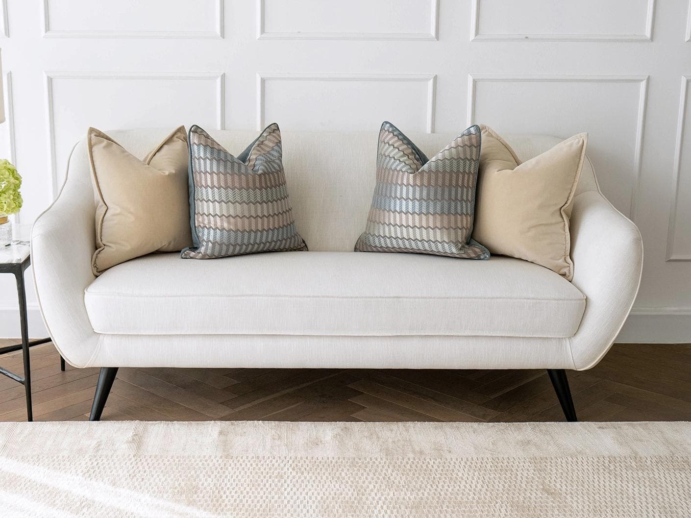Nilla Bundle cushion in silver, blue and beige, shown in a lifestyle front view as image 4