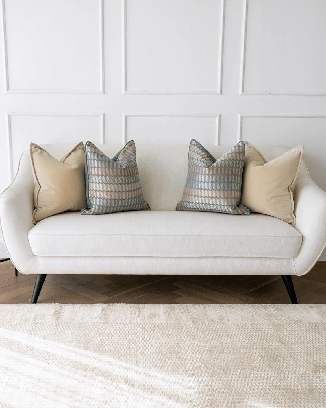 Nilla Bundle cushion in silver, blue and beige, shown in a lifestyle front view as image 4