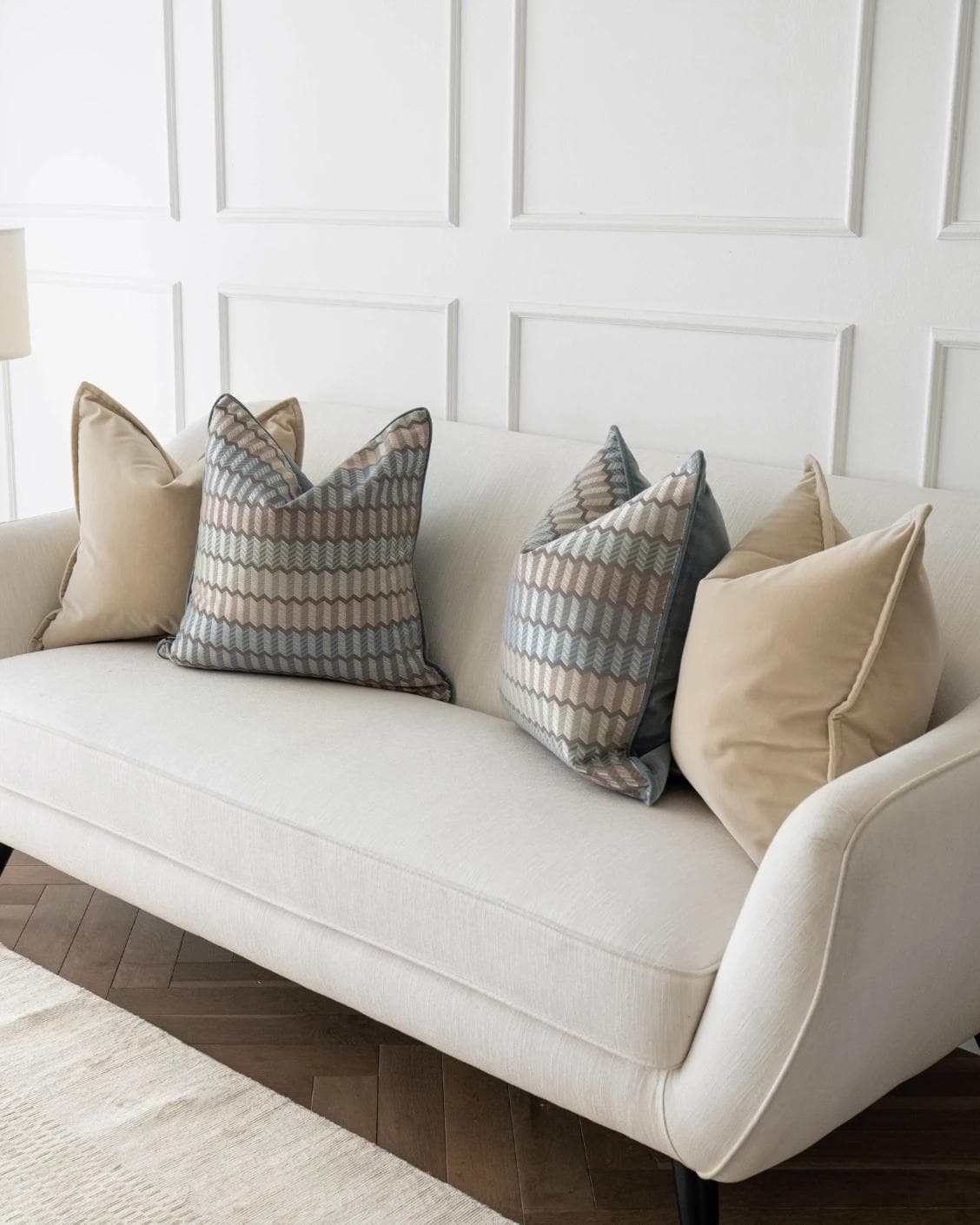 Nilla Bundle cushion in silver, blue and beige, shown in a lifestyle right view as image 2