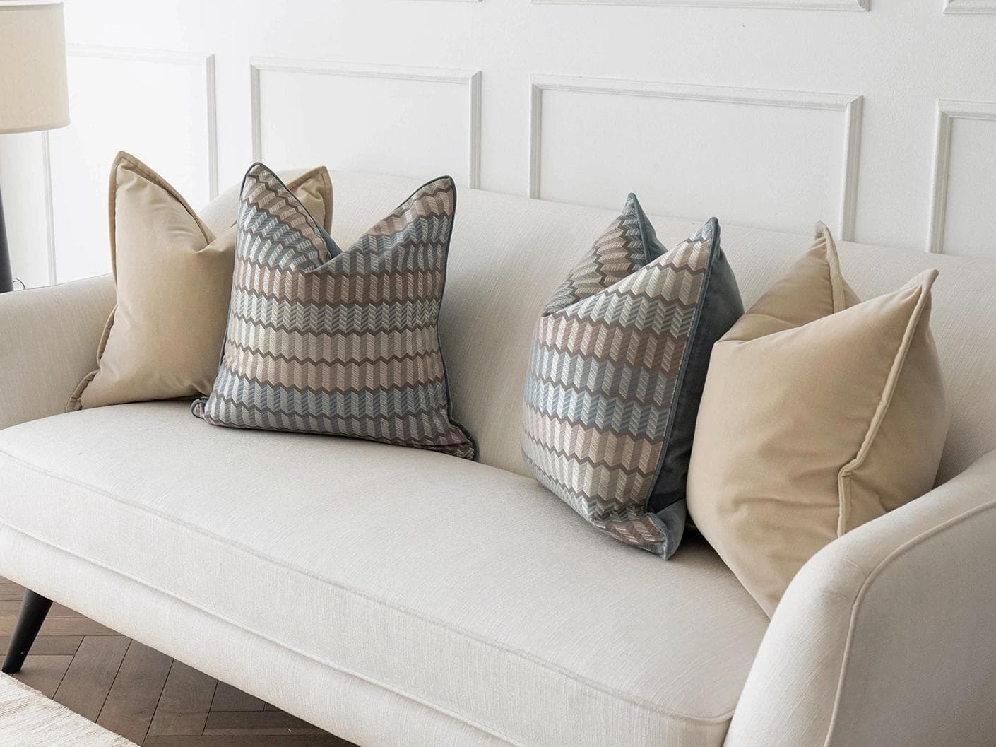 Nilla Bundle cushion in silver, blue and beige, shown in a lifestyle right view as image 2