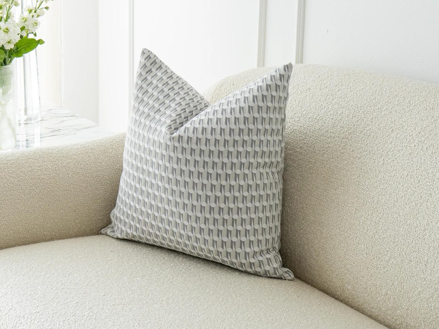 Paul Canova cushion in grey, shown in a lifestyle front view as image 2