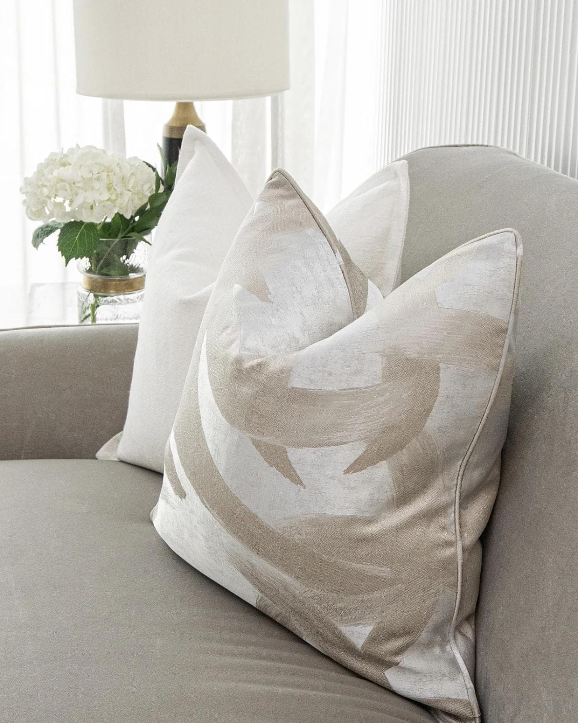 Harry Bundle cushion in gold, beige, silver and white, shown in a lifestyle front view as image 4