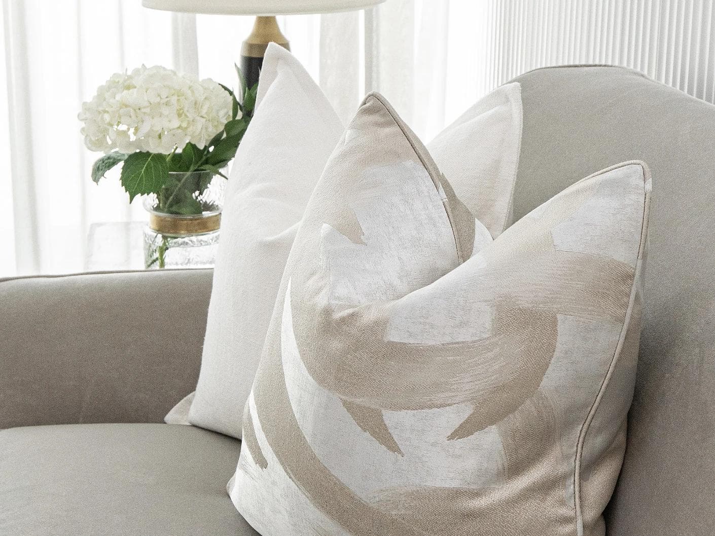 Harry Bundle cushion in gold, beige, silver and white, shown in a lifestyle front view as image 4