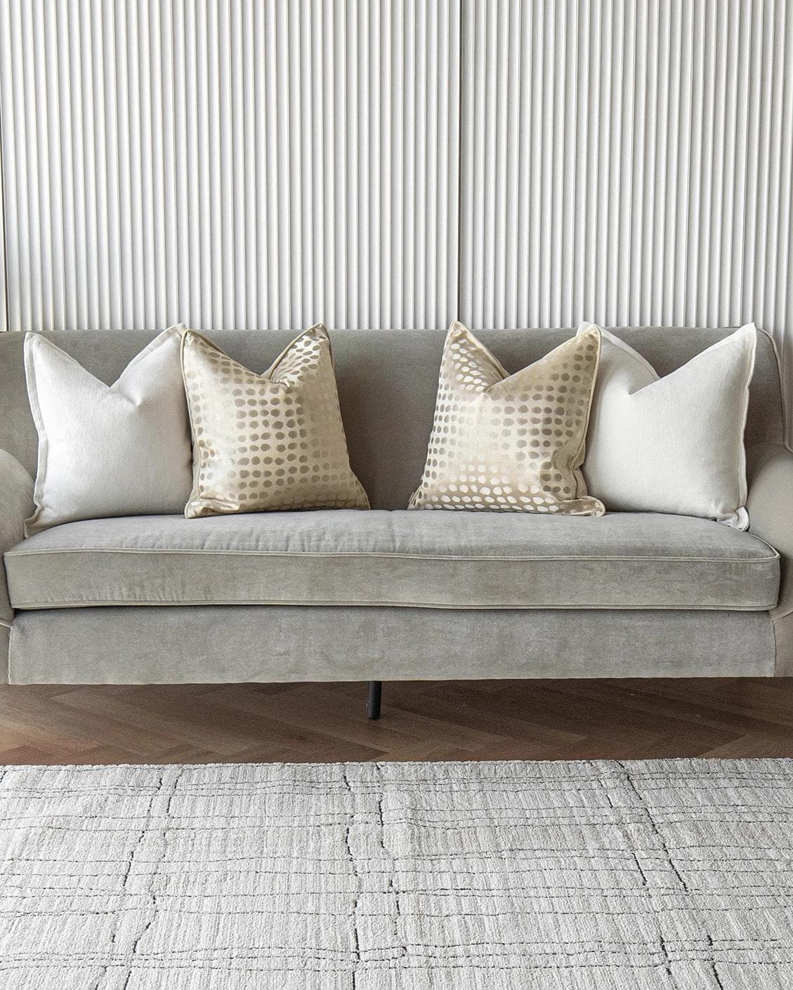 Myla Bundle cushion in white, beige and gold, shown in a lifestyle front view as image 4