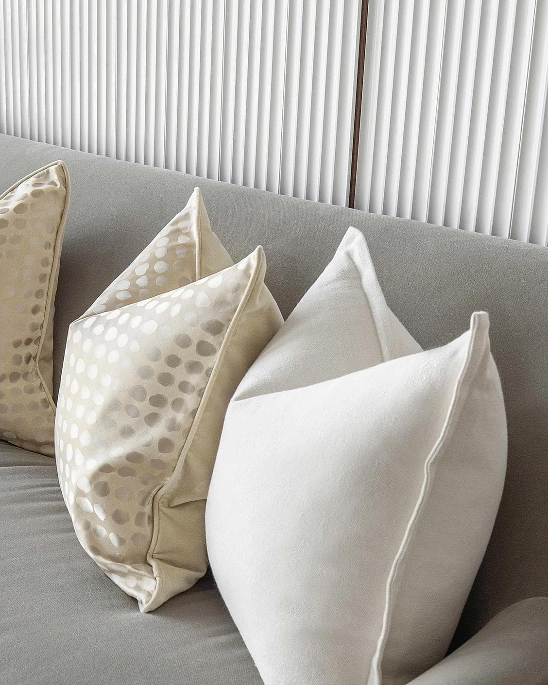 Myla Bundle cushion in white, beige and gold, shown in a lifestyle right view as image 5